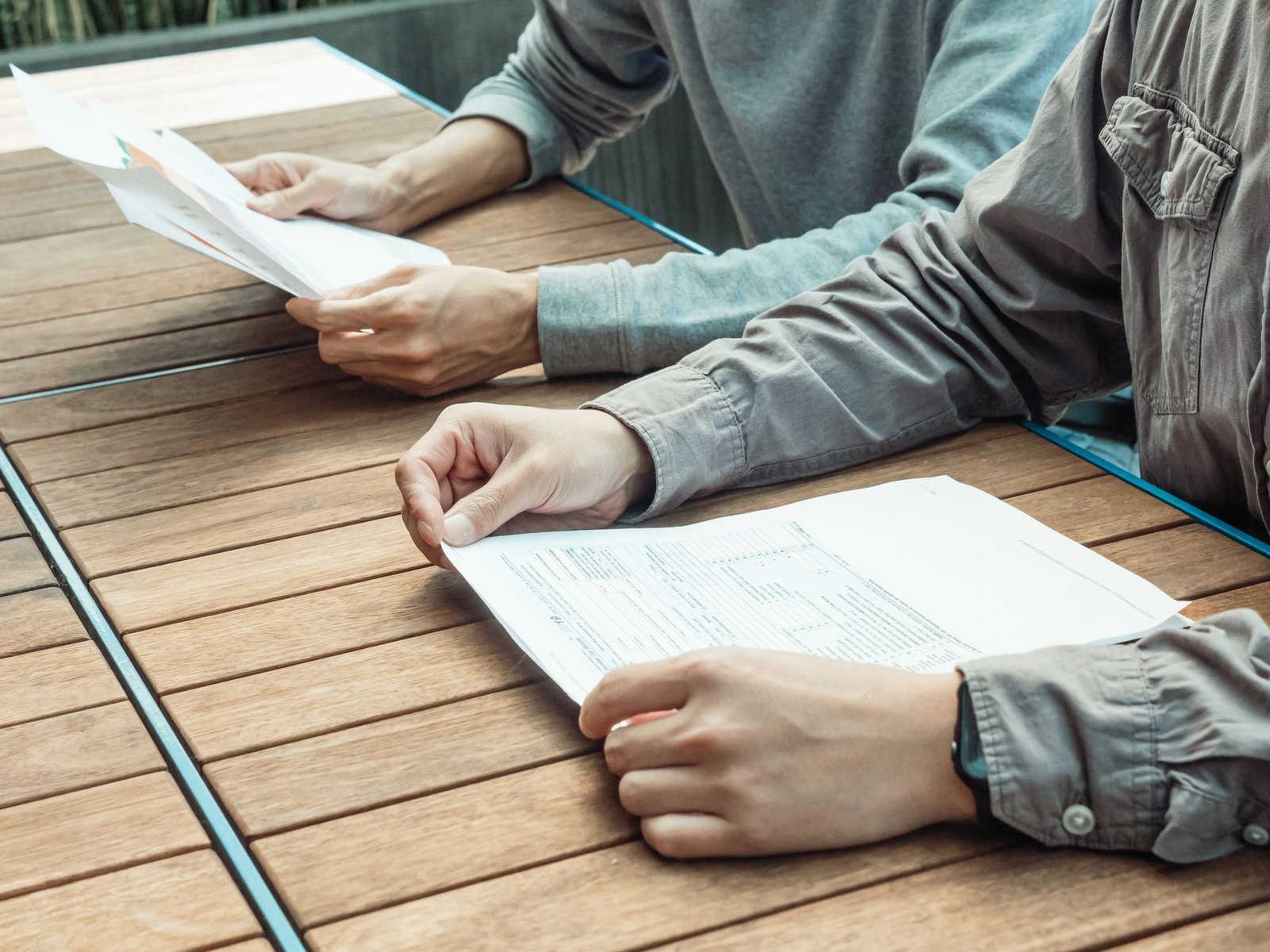 Two people reviewing short term disability benefit forms together at an office table
