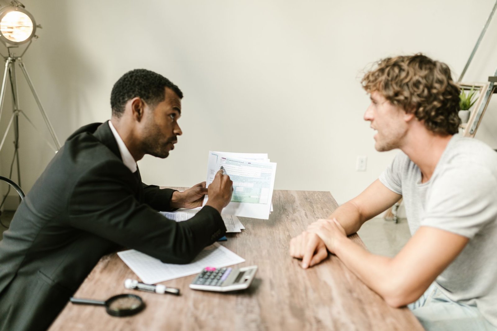 Two people reviewing an employer health plan appeal file together at a table